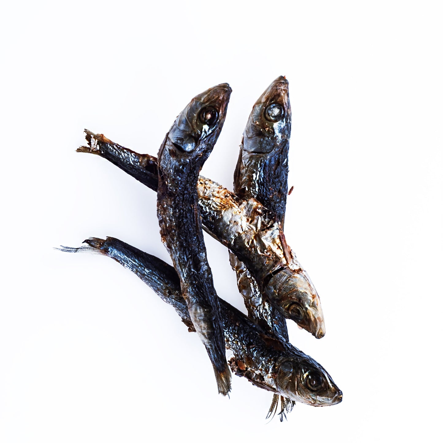 Three dried fish on a white background
