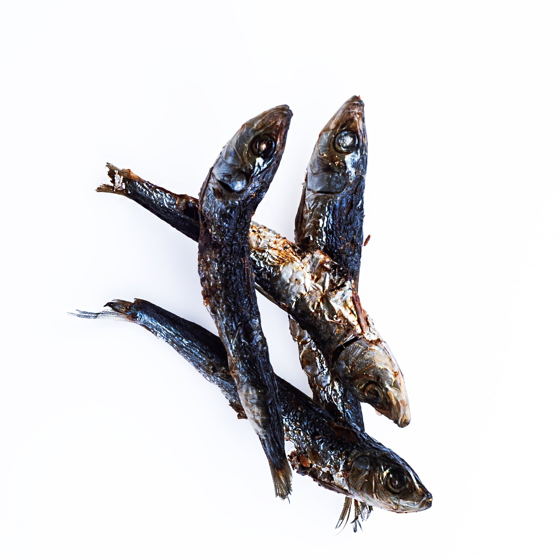 Three dried fish on a white background